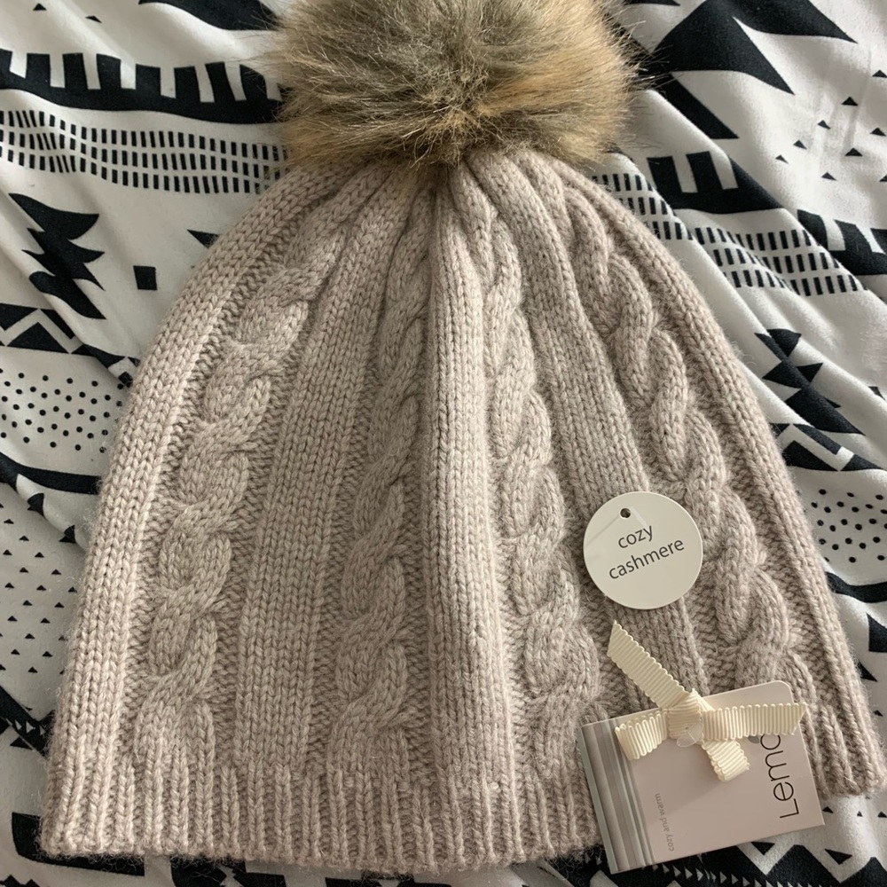 Knitted beanie hat with fur ball